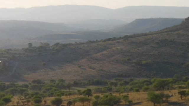 Flying over mountain ranges in the warm savanna