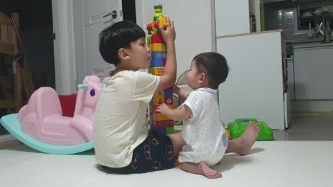 brother playing with blocks