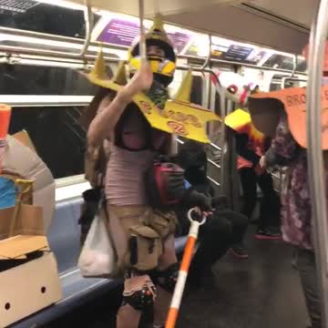 Guys in different costumes dancing on subway