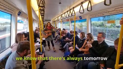 Amazing woman inspires train sing along