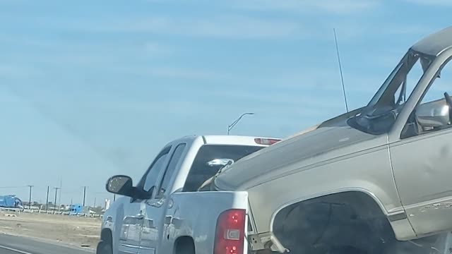 Truck Hauls another Truck Cab down Highway