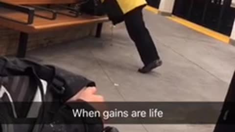 Man does semi-pushups off of a seat in a subway station