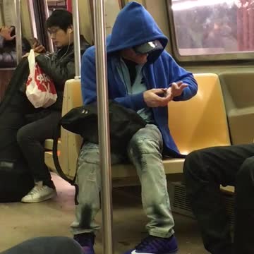 Blue hoodie guy clips nails on subway