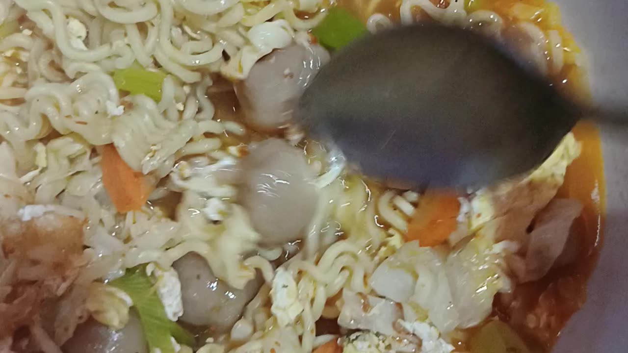 boiled noodles mixed with vegetables and meatballs