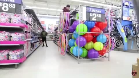 Guy climbs into ball bin at walmart