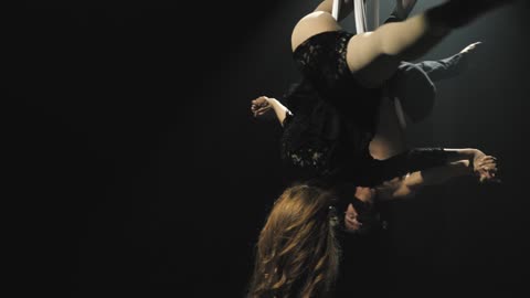 Man and woman doing aerial aerobics