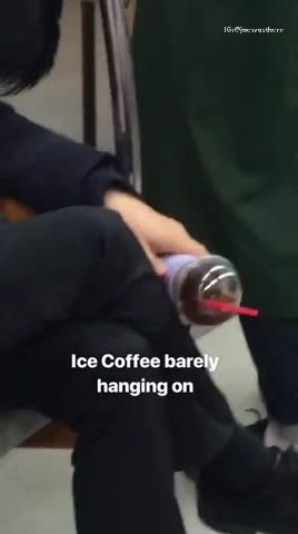 Ice coffee barely hanging on man asleep on subway