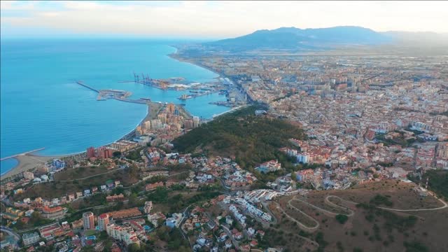 malaga spain a panorama shot by a drone over malaga city buildings and seaside view ships and port