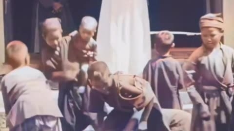 Throwing small coins and grains in front of Annamite children in French Indochina (today Vietnam)