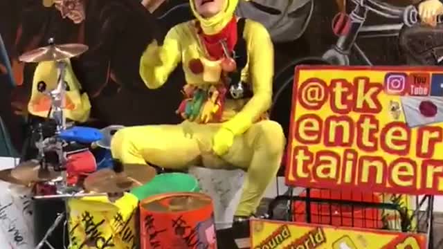 Chicken outfit man playing drums