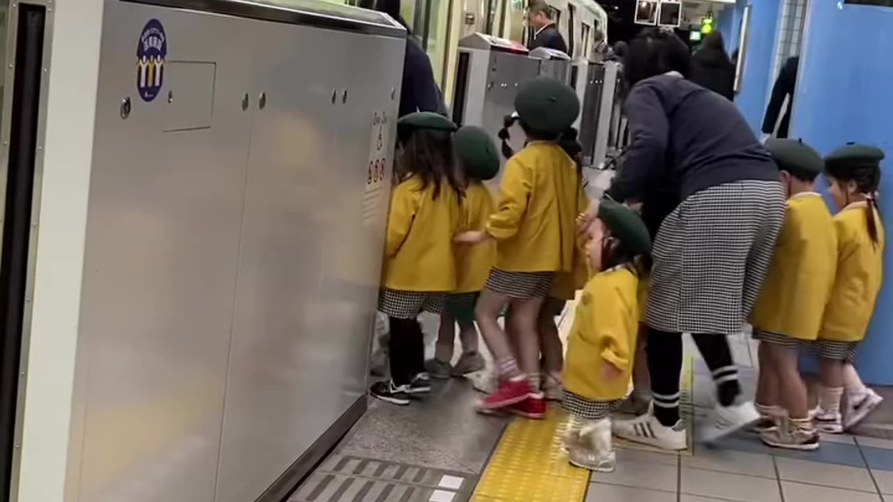 Cute Japanese kids waiting for the train.