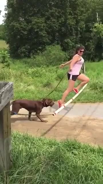 Ladies jumping with dog jumping tricks shots