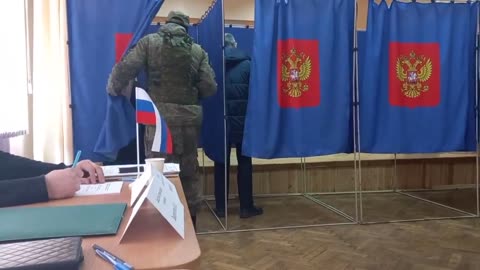 A video of an armed military man checking voting booths has surfaced online