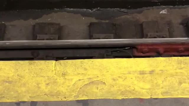 Two rats fighting for pizza subway train tracks