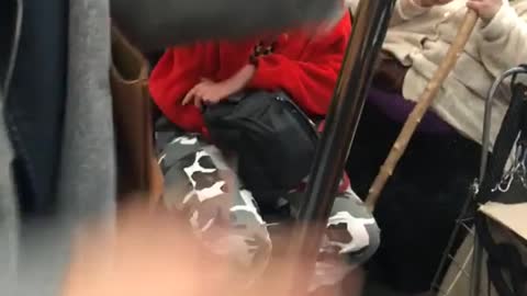 Woman in white cutting her cane on train 