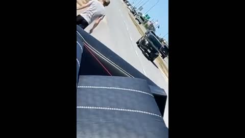 Couch cushion flies onto freeway as guy moves sofa on his truck and goes to retrieve it