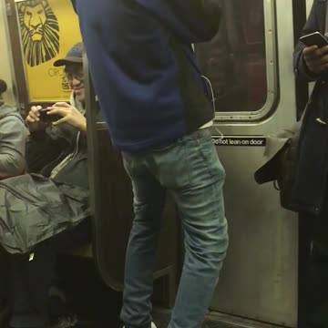Blue jacket guy dances in subway window