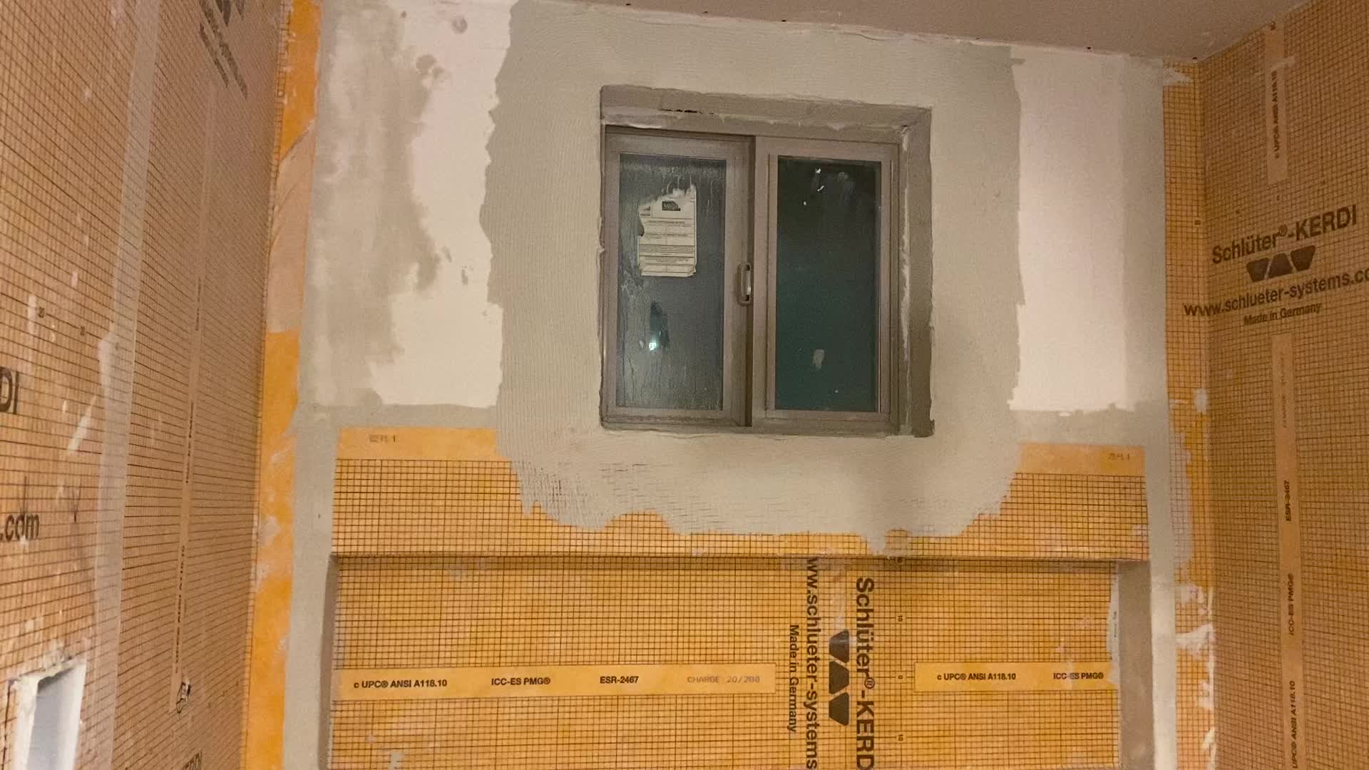 Wrapping the shower window with the Kerdi Membrane.