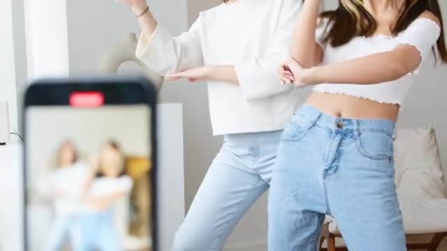 Two sisters are making Tik Tok videos