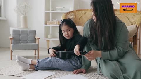 A mother teaches her daughter to play music