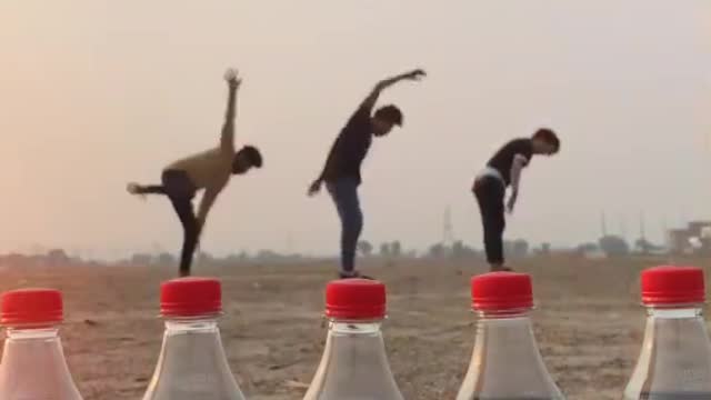 They jump over huge Coca-Cola bottles