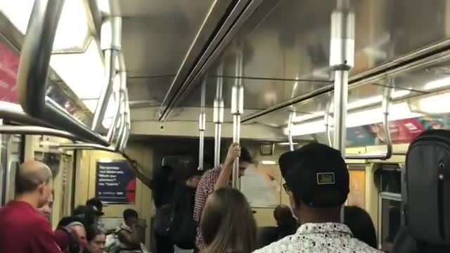 Guys play hip hop music and take over pa system on train