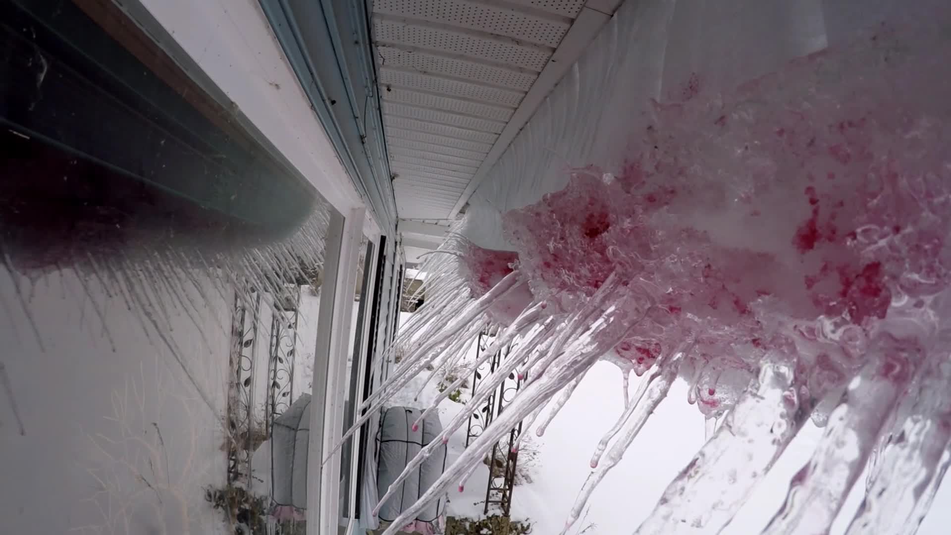 Ice and snow creeping down my eves with strange red color.