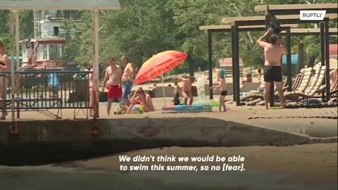 Desire to relax is greater than the fear' -Mariupol residents rest on demined city beach.