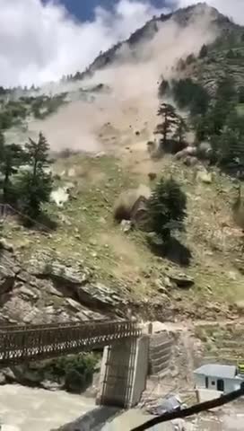 India - Rockslide boulders destroy a bridge