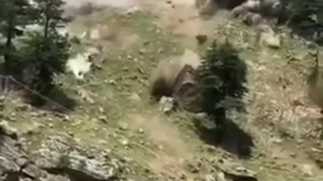 India - Rockslide boulders destroy a bridge