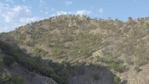 Aerial tour between the arid hills of a mountain range