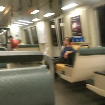 Person rides scooter through subway train speed lime