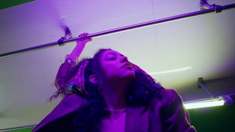 Slow dancing girl looking at the lens inside a bus