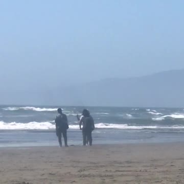 Man taking pictures on beach