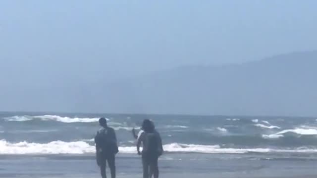 Man taking pictures on beach