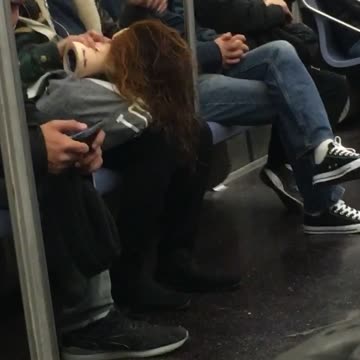 Girl touching hair of doll with brown hair