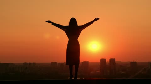 Woman during a sunset on a rooftop