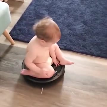 Baby boy playing with the vacuum cleaner