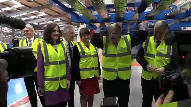 Boris Johnson does pull-ups on Routemaster bus chassis