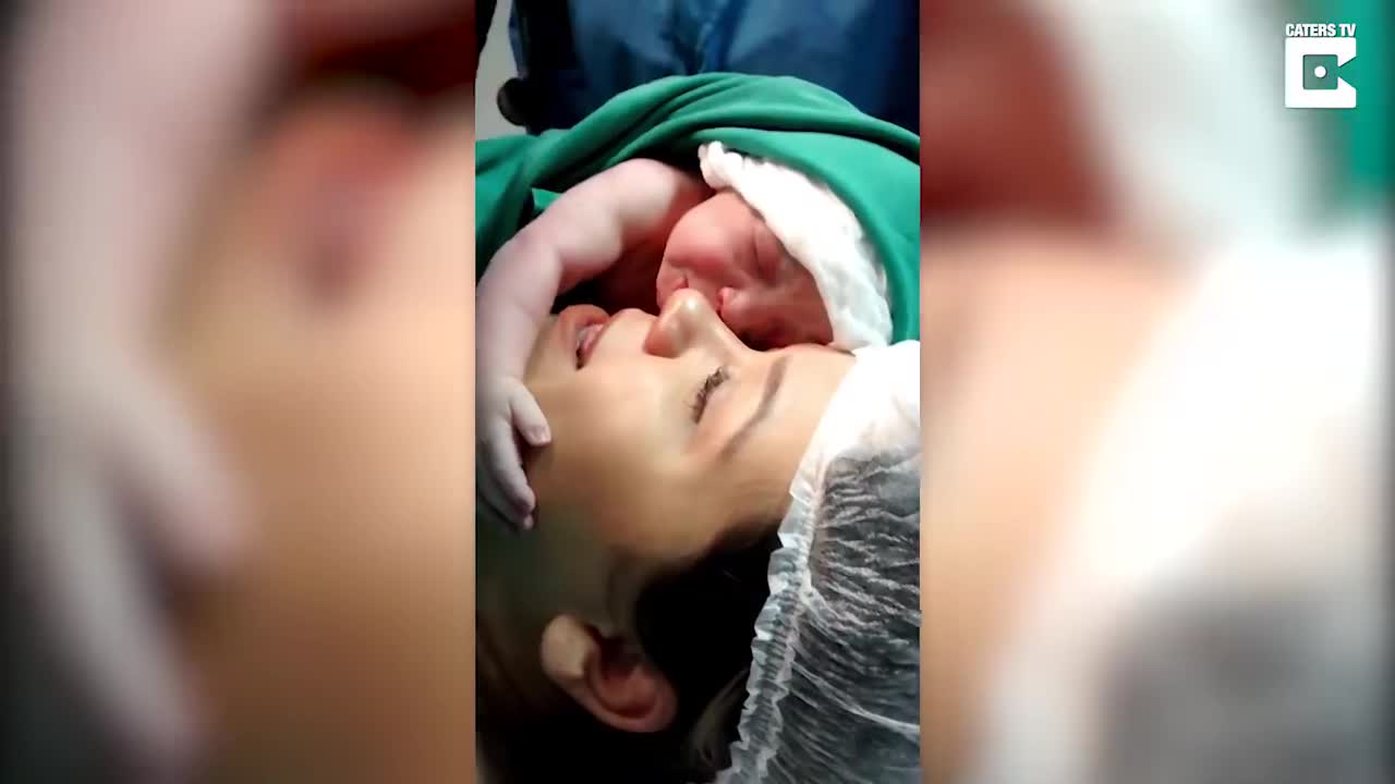 Emotinal moment new born clings to mother's face