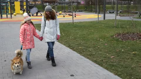 Mother and daughter walking through the park