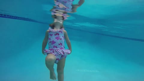 Two-year-old swims in pool all by herself