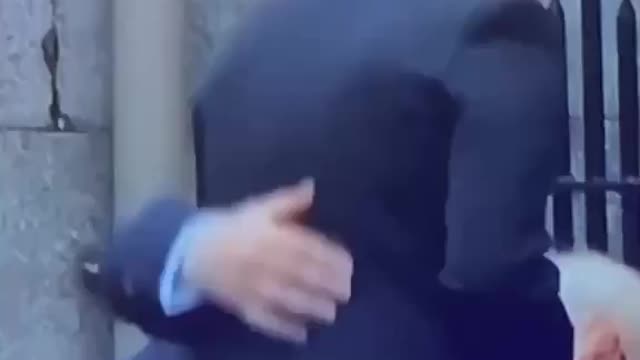 Look at Prince Andrew's hands