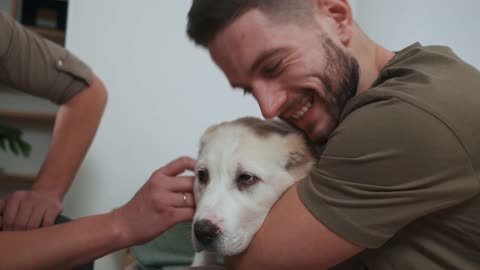 Men Petting and Hugging Dog