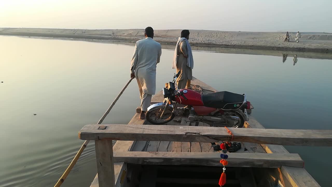 Crossing river chinab by boat.