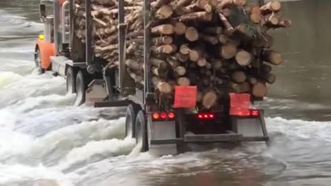 Logging Truck Crosses Flooded Road