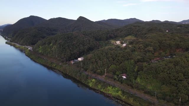 Drone view flying by the river beyond the magnificent lake