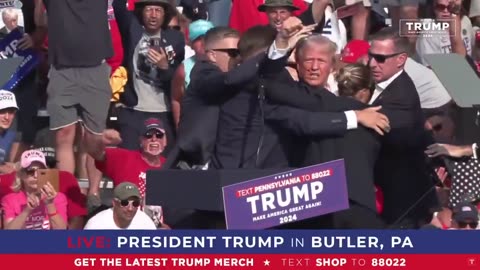 President Trump raises his fist in victory after being shot