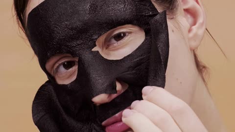 A woman wears a mask over her face