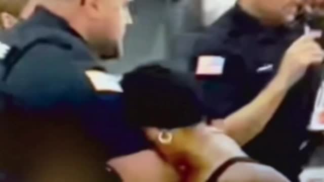 COP PUNCHES WOMAN IN THE FACE